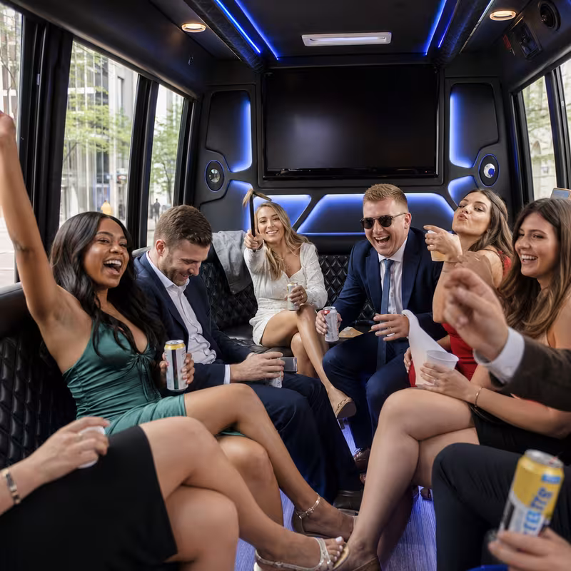 Party bus interior with wraparound leather seating and LED lighting in Indianapolis