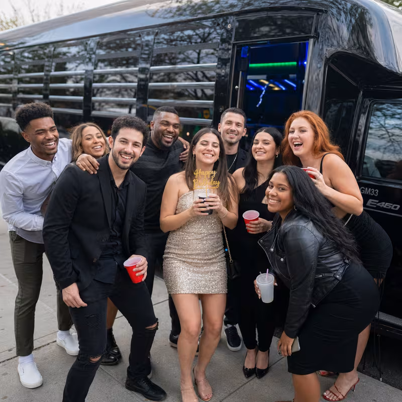 Group boarding a white charter bus for Birthday Transportation transportation in Indianapolis