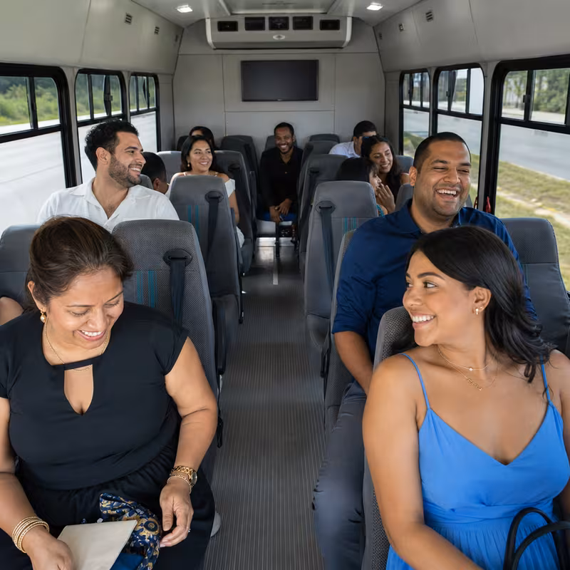 Group boarding a white charter bus for Private Event Transportation transportation in Indianapolis