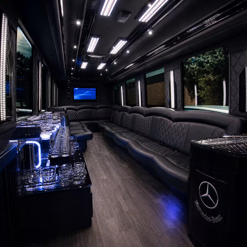 Party bus interior with wraparound leather seating and LED lighting in Indianapolis