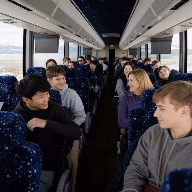 Group boarding a white charter bus for School Transportation transportation in Indianapolis