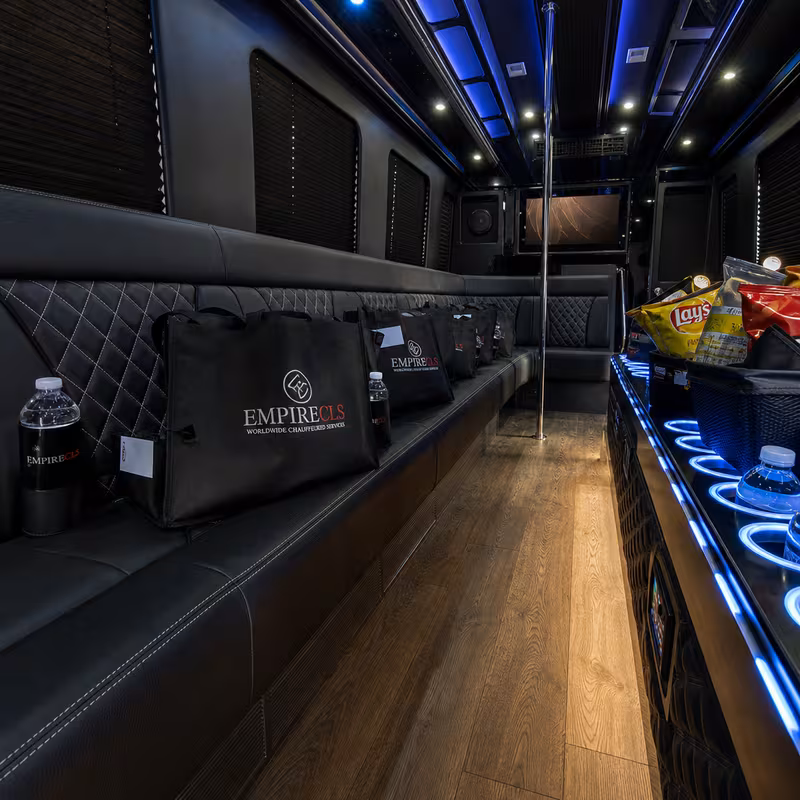Party bus interior with wraparound leather seating and LED lighting in Indianapolis